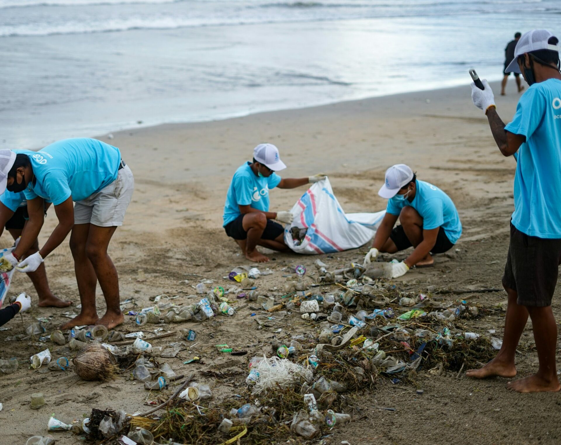 Volunteers cleaning up trash washed up on the coastline